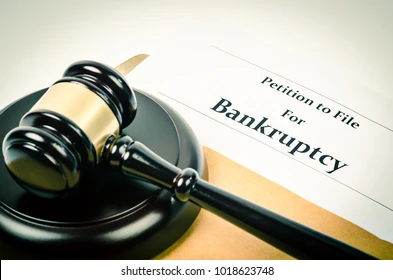 Image of a gavel and document with the caption 'Petition to File for Bankruptcy'