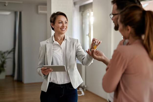 Woman in a coat speaking to the tenants of the house.